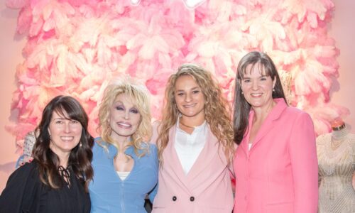 Charlotte Poling, left, Dolly Parton, Jamie Reschke, and Dr. Candice McQueen, right, pose together at the exhibit