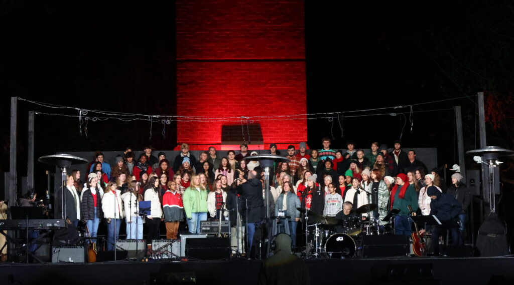 Choir performing on stage at the 19th annual Lighting of the Green