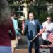 San Lynn, director of veteran services, handing out American flags during the 9/11 observance.