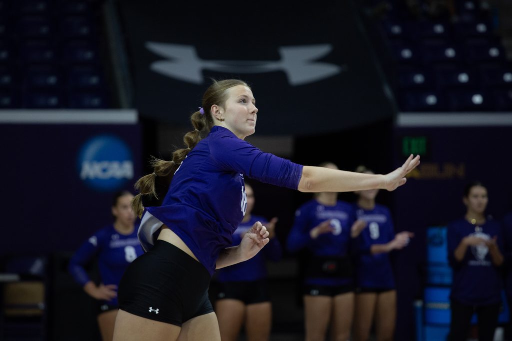 Sr. Ella Durham serves the ball.